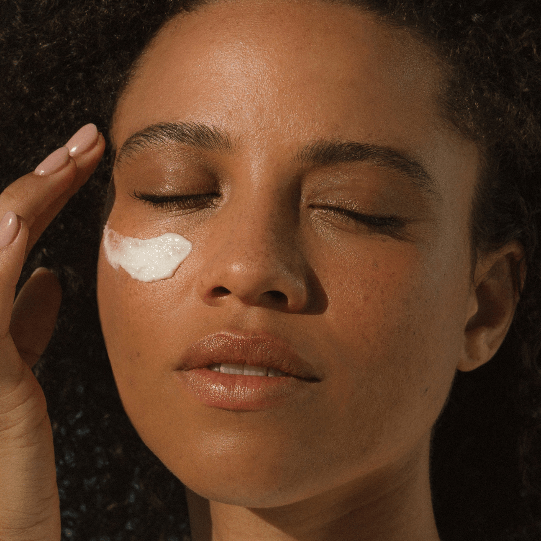 Close-up of a woman applying Glory Cream to her face. - Eco By Sonya UK